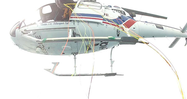 Exiting the helicopter above the Cook Strait. Photo: Matt Stanford