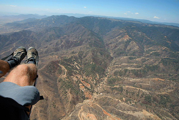 Flying the Sierra Madre, with the road to take-off on the far ridge. Photo: Ed Ewing