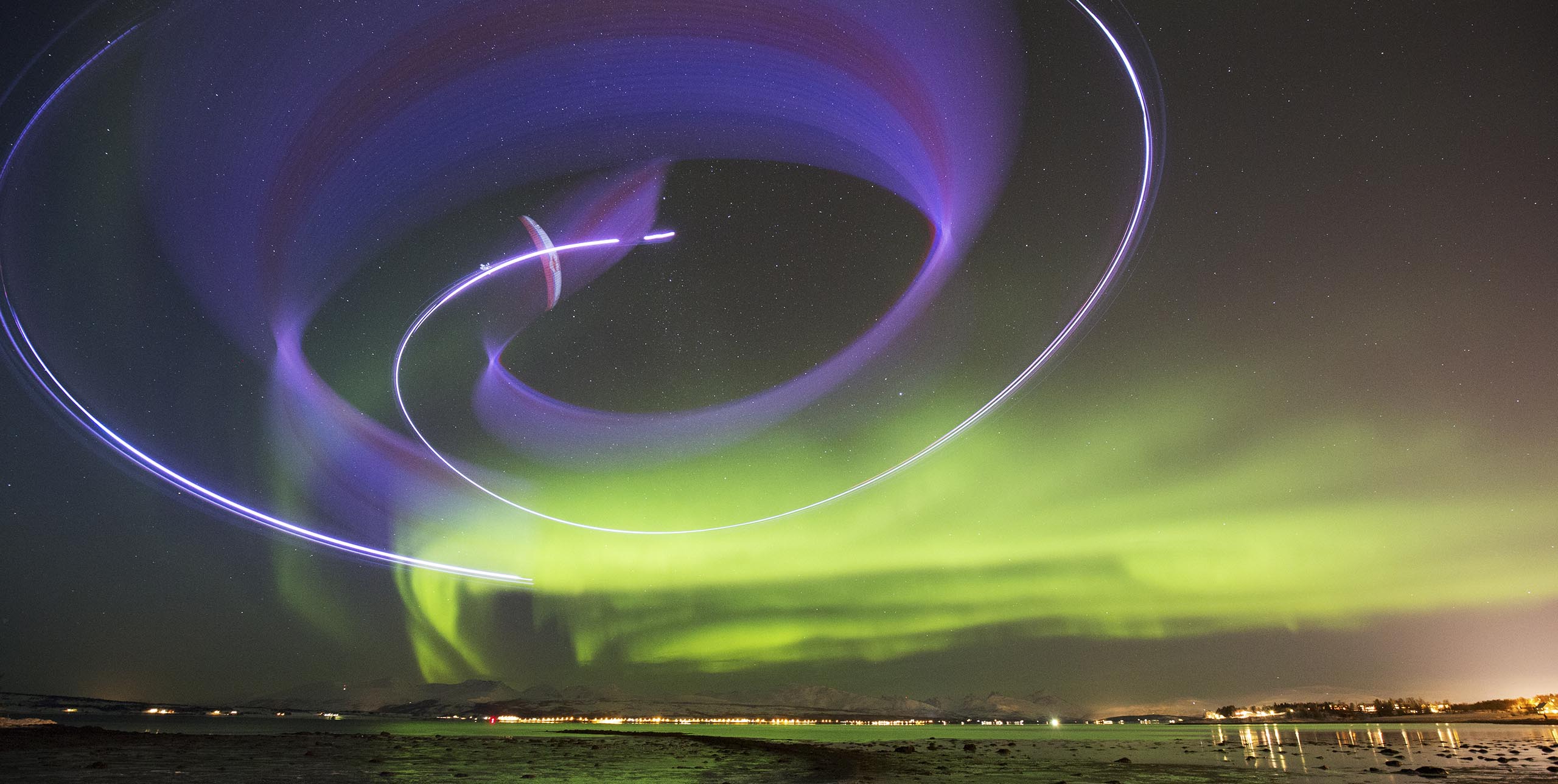 Horacio Llorens paramotoring with the Northern Lights in Norway. Photo: Frode Sandbech / Red Bull Content Pool