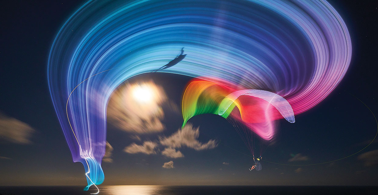 Ivan Fominykh paraglides by the light of a full moon in Bali, Photo by Serge Shakuto