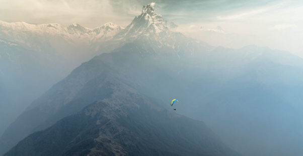 Cody Tuttle paragliding in front of Machapuchare, Nepal