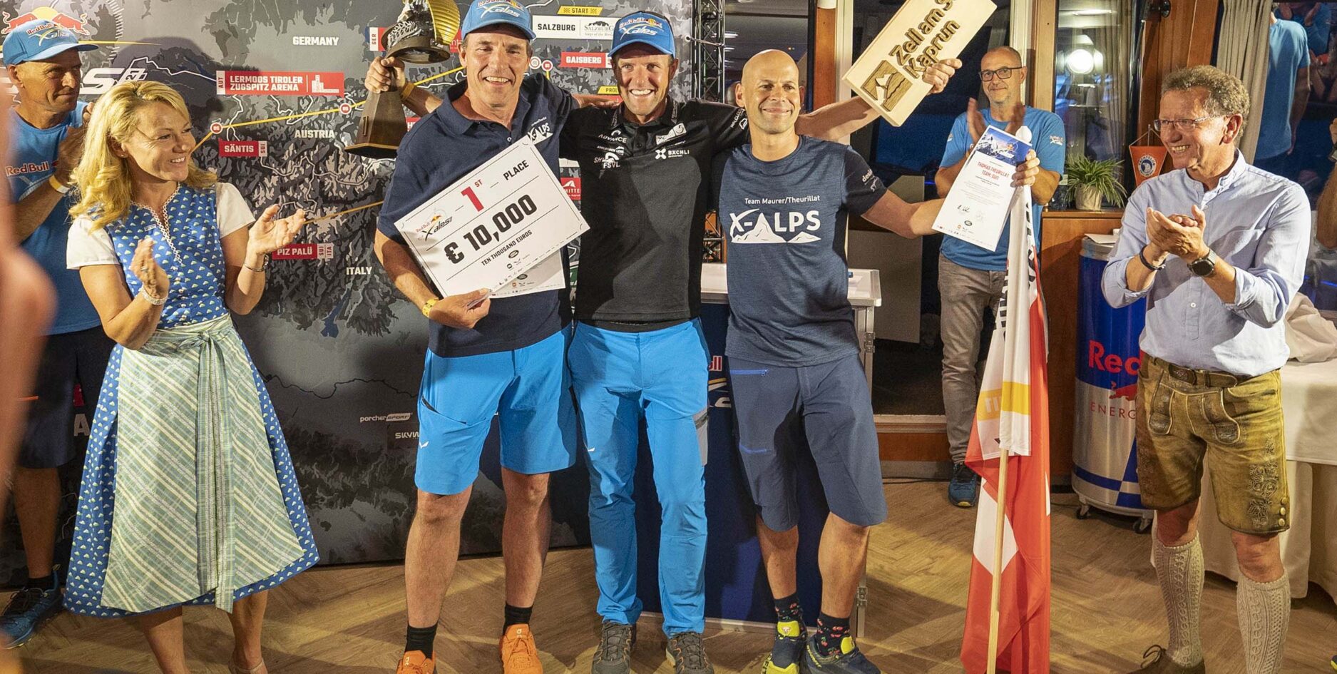 Chrigel Maurer (centre) and Thomas Theurillat (right) at the prize-giving at the the end of the Red Bull X-Alps 2021. Photo: Lukas Pilz / Red Bull Content Pool