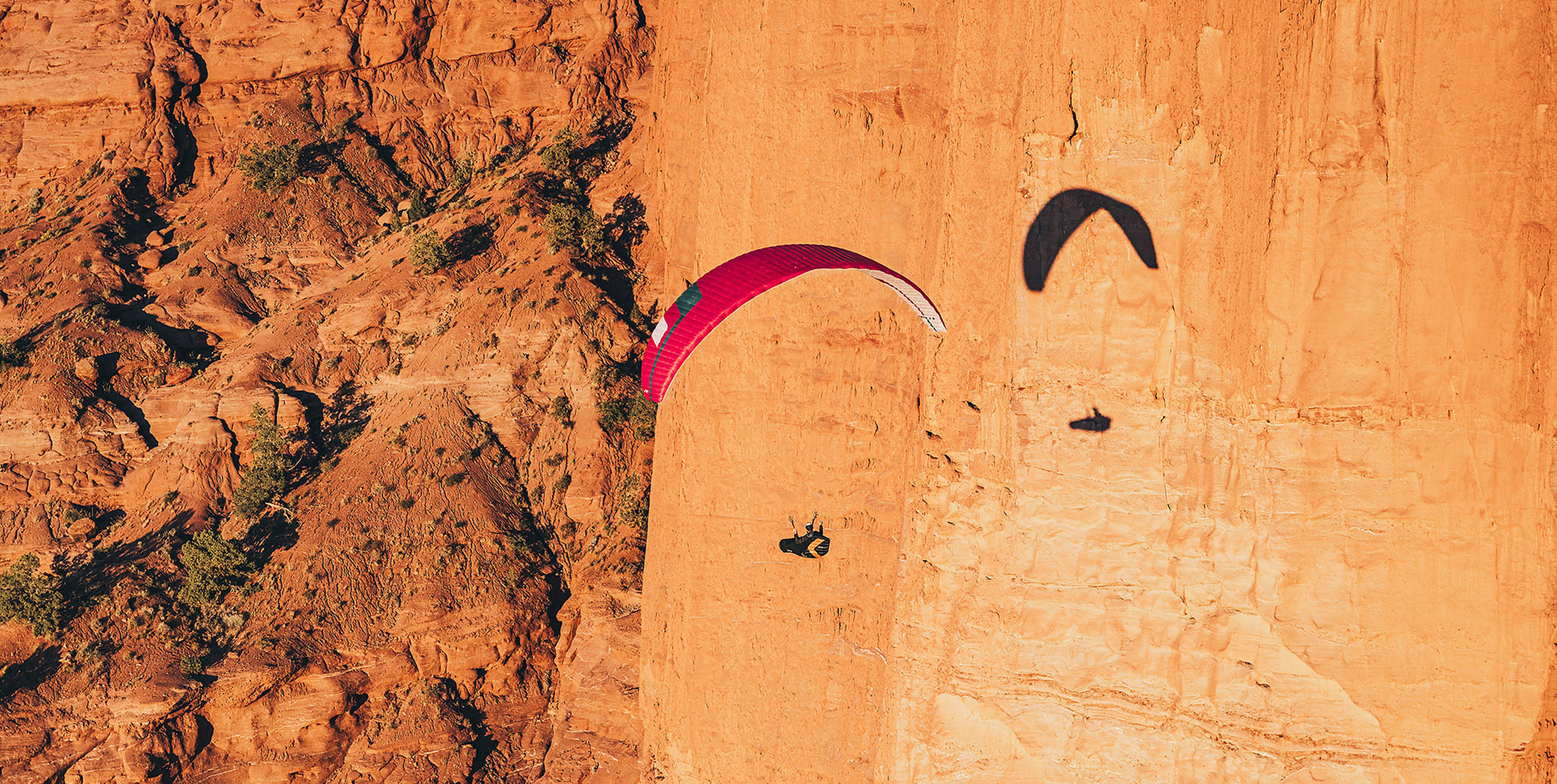 Paragliding at sunset along steep cliffs in Utah, USA