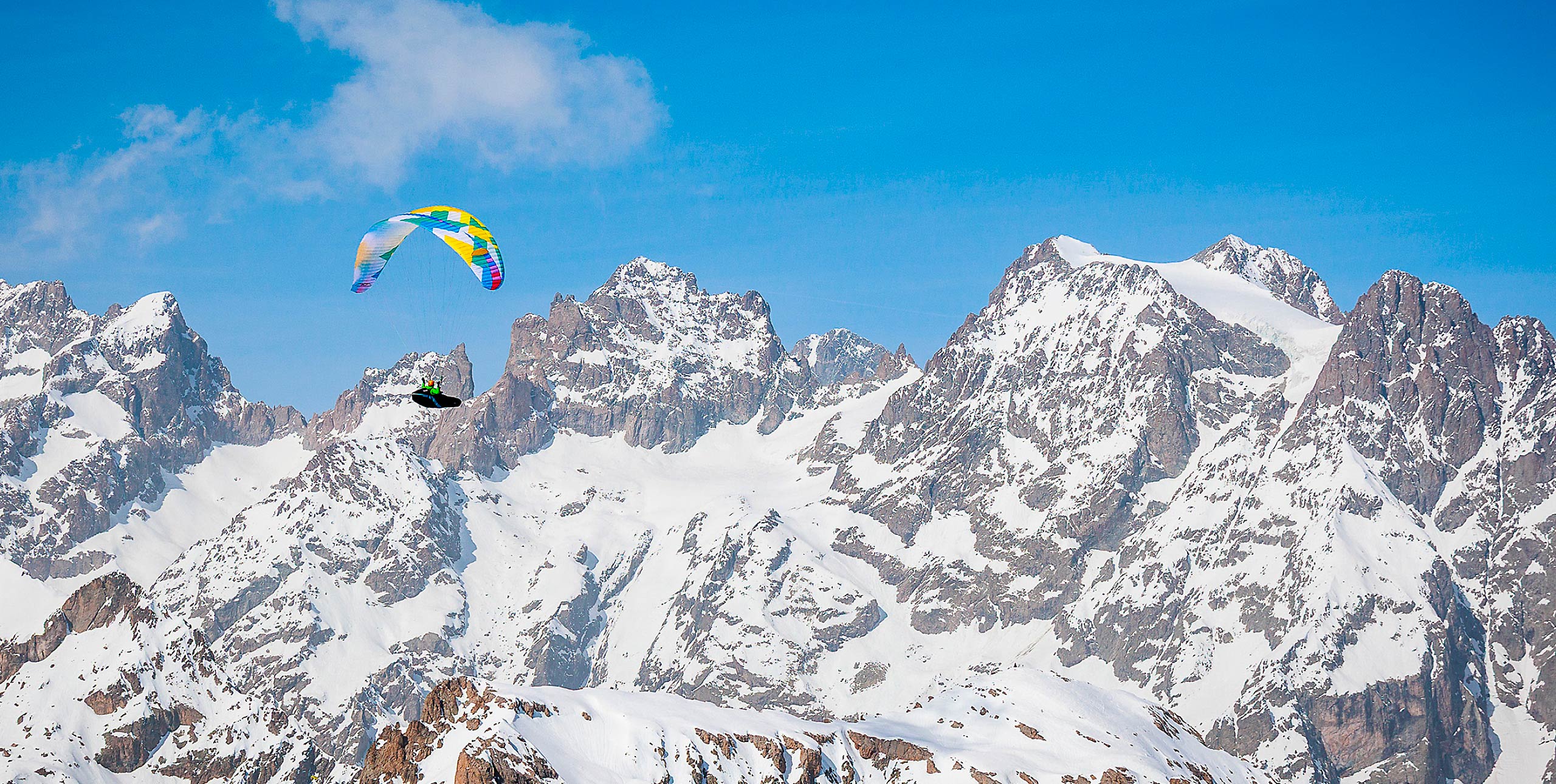 Charlie King flies above the Écrins