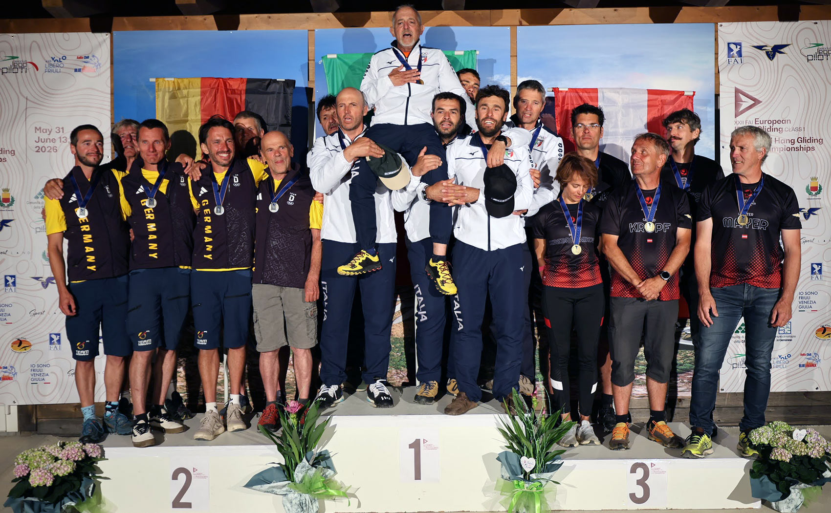 Flavio Tebaldi is hoisted onto the shoulders of his teammates at the European Hang Gliding Championships 2026. Photo: FAI